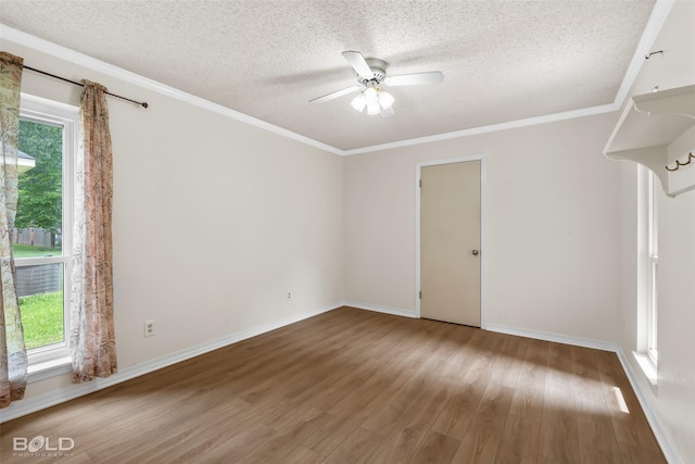 unfurnished room with plenty of natural light, a textured ceiling, ceiling fan, and wood finished floors