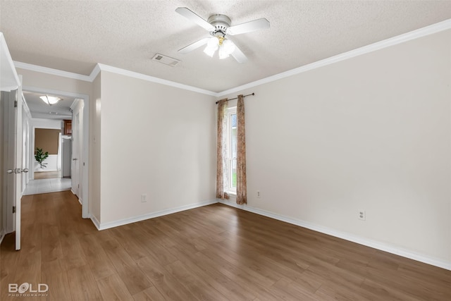 spare room featuring baseboards, a textured ceiling, and wood finished floors