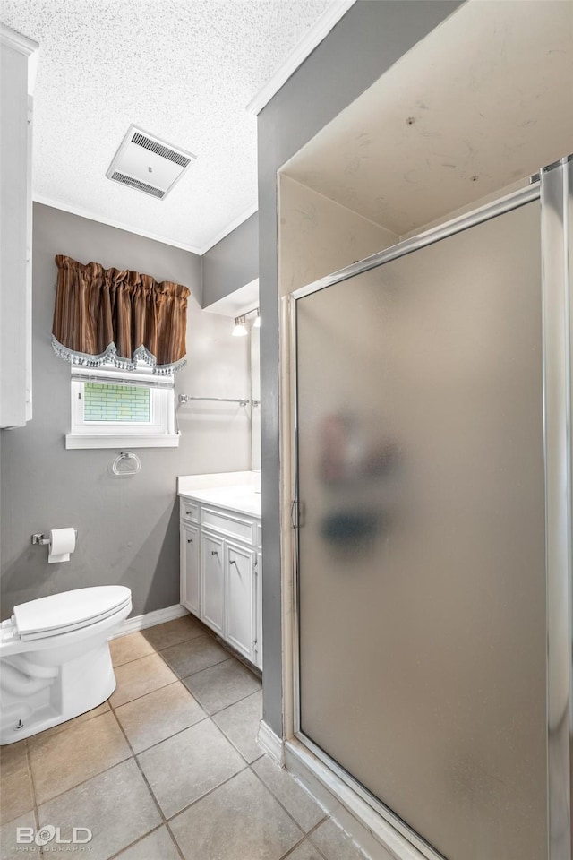 bathroom featuring tile patterned flooring, vanity, toilet, a shower stall, and visible vents