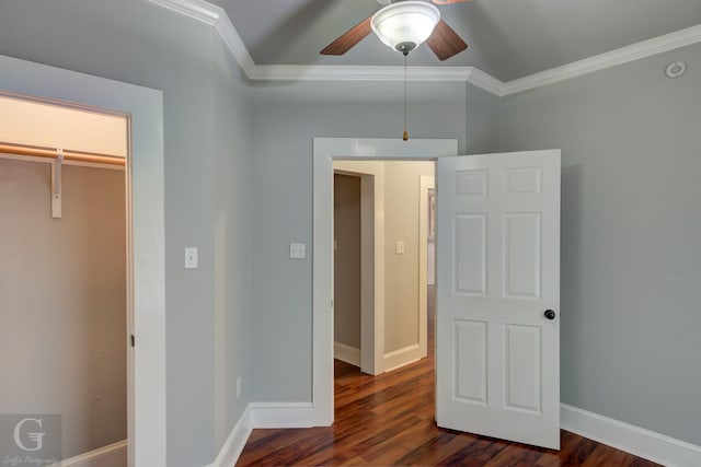 unfurnished bedroom with crown molding, baseboards, a ceiling fan, and dark wood-style flooring