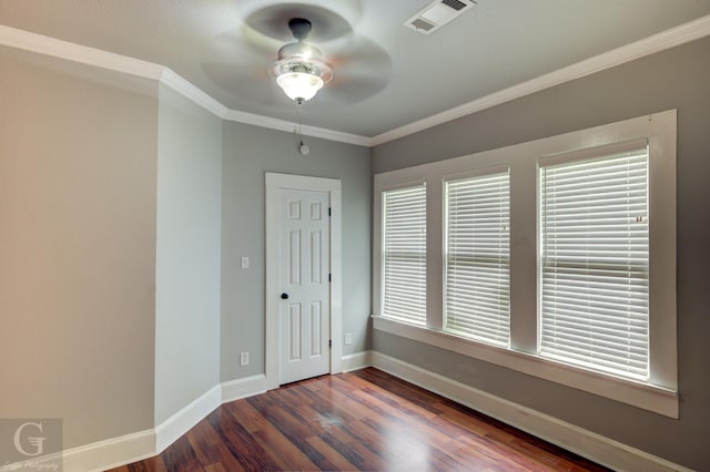 empty room featuring ceiling fan, visible vents, crown molding, wood finished floors, and baseboards