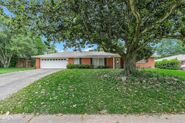 ranch-style house featuring fence, a front yard, brick siding, concrete driveway, and an attached garage