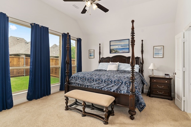 bedroom featuring a ceiling fan, light colored carpet, lofted ceiling, and visible vents
