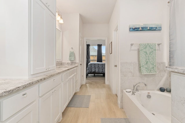ensuite bathroom with vanity, ensuite bathroom, and a bath