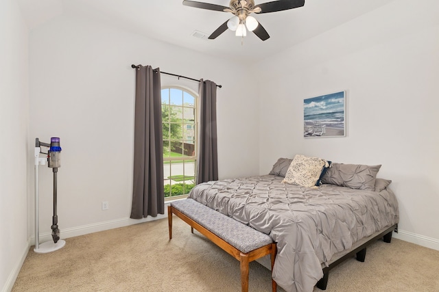 bedroom featuring baseboards, visible vents, light carpet, and lofted ceiling
