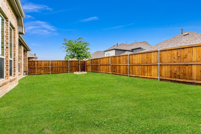view of yard with a fenced backyard
