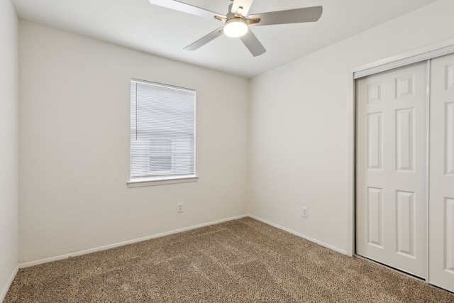 unfurnished bedroom with a closet, carpet, and baseboards