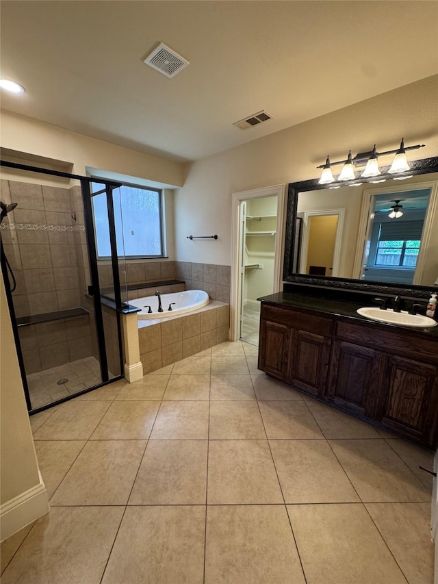 2823 Millington Dr, Highland Village, TX 75077 - full bath featuring a bath, a shower stall, vanity, and tile patterned floors