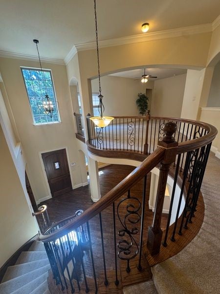2823 Millington Dr, Highland Village, TX 75077 - staircase featuring baseboards, a chandelier, ornamental molding, ceiling fan, and arched walkways