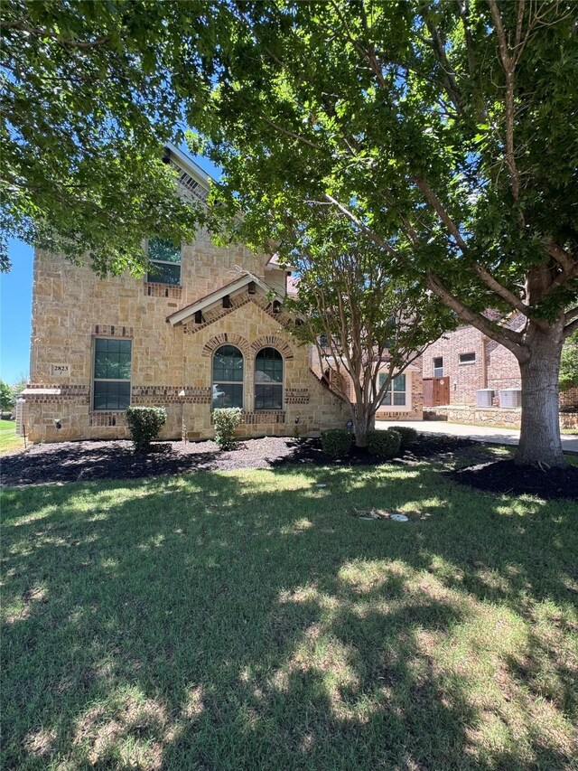 2823 Millington Dr, Highland Village, TX 75077 - view of front of house with stone siding and a front lawn