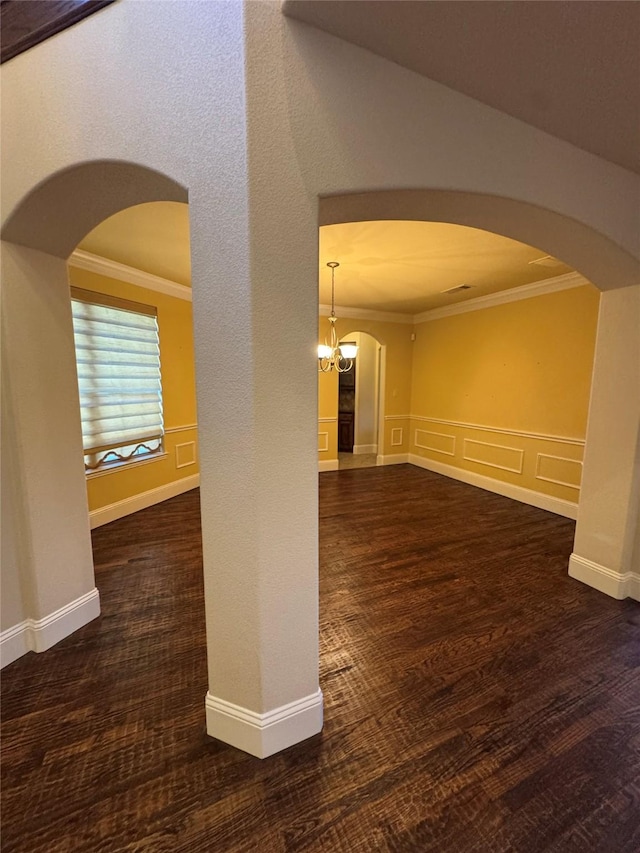 2823 Millington Dr, Highland Village, TX 75077 - empty room featuring arched walkways, ornamental molding, wood finished floors, a chandelier, and baseboards