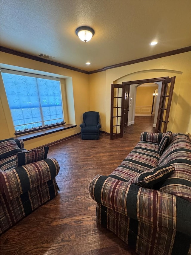 2823 Millington Dr, Highland Village, TX 75077 - living area with arched walkways, crown molding, wood finished floors, a textured ceiling, and baseboards