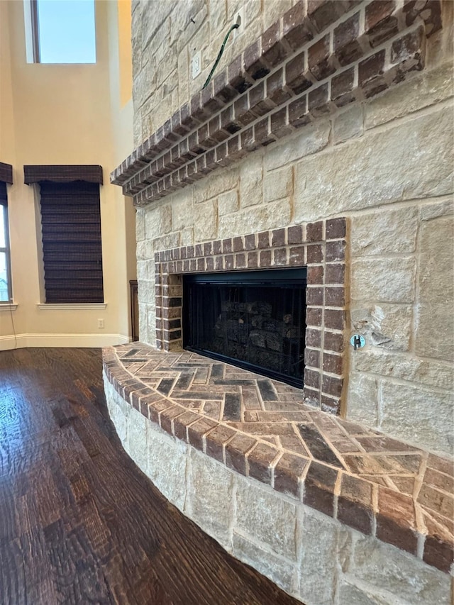 2823 Millington Dr, Highland Village, TX 75077 - detailed view of baseboards, a fireplace with raised hearth, and wood finished floors
