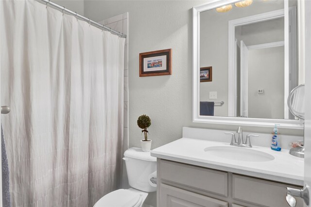 602 Limmerhill Dr, Rockwall, TX 75087 - bathroom featuring vanity, a textured wall, a shower with curtain, and toilet