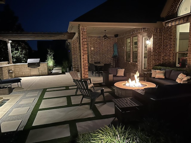 602 Limmerhill Dr, Rockwall, TX 75087 - patio at night with area for grilling, outdoor dining area, and an outdoor living space with a fire pit