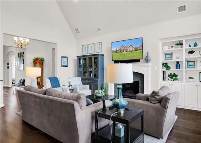 602 Limmerhill Dr, Rockwall, TX 75087 - living area featuring high vaulted ceiling, visible vents, an inviting chandelier, and a high end fireplace