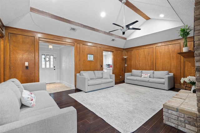 living room with vaulted ceiling with beams, dark wood finished floors, ceiling fan, and visible vents