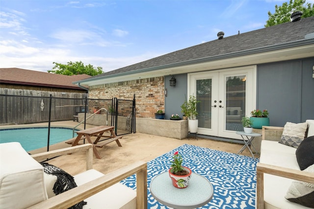 view of patio / terrace with a fenced in pool, fence, and french doors