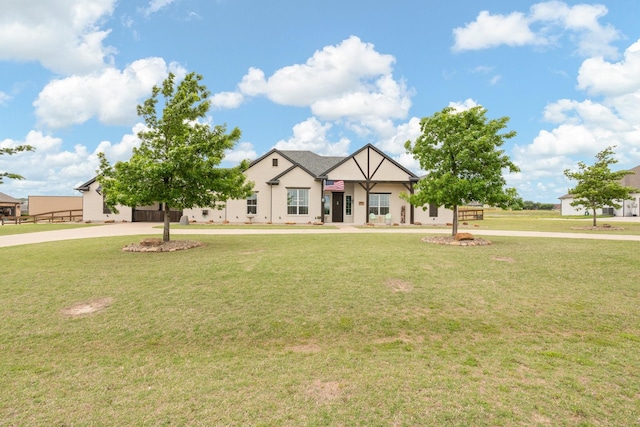 view of front of house featuring stucco siding and a front yard