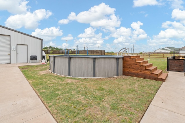 view of yard with fence and an outdoor pool