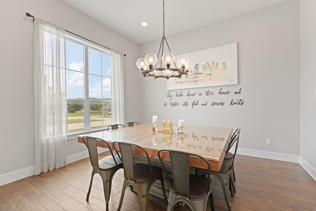 dining space featuring baseboards, recessed lighting, a notable chandelier, and light wood-type flooring