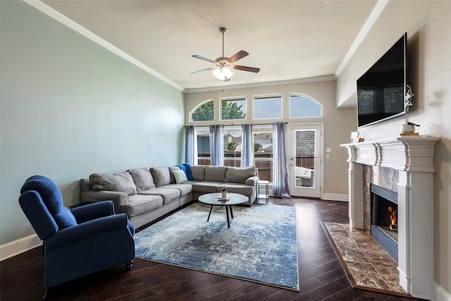 living area featuring ceiling fan, ornamental molding, wood finished floors, and a premium fireplace