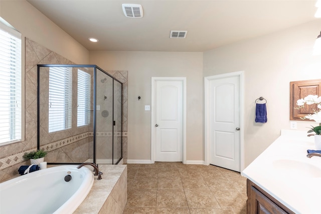 full bathroom with visible vents, a sink, a bath, and a stall shower