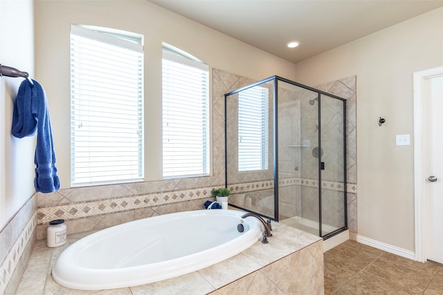 full bath featuring tile patterned floors, a stall shower, and a bath