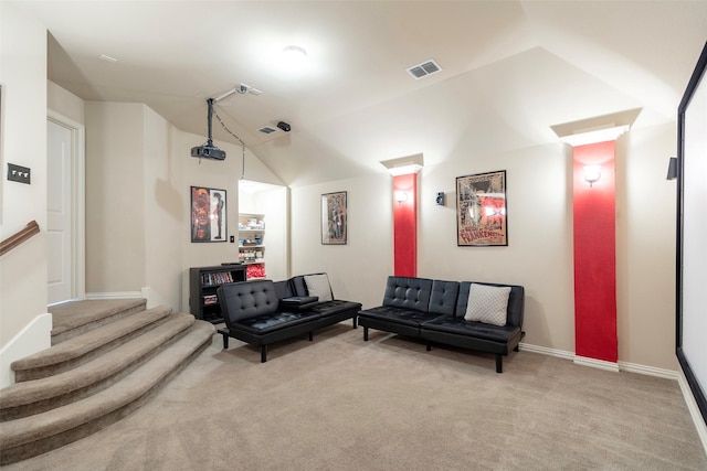 interior space featuring carpet flooring, baseboards, visible vents, and vaulted ceiling