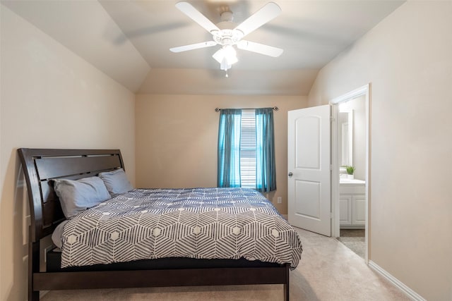 bedroom featuring ceiling fan, lofted ceiling, connected bathroom, and light colored carpet