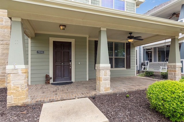 property entrance with covered porch and ceiling fan
