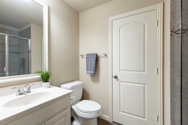 full bath featuring vanity, toilet, and a stall shower