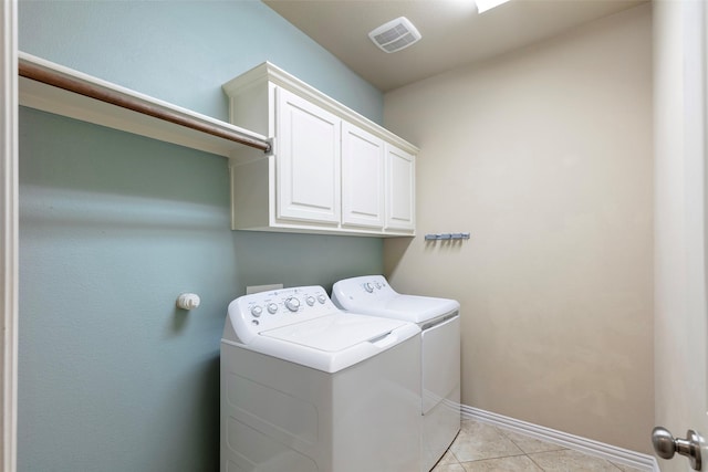 washroom featuring cabinet space, separate washer and dryer, baseboards, light tile patterned floors, and visible vents