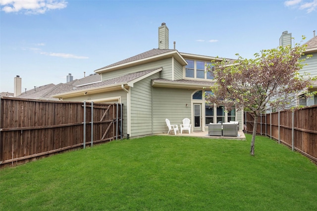 back of house with a fenced backyard, a patio area, a yard, and a chimney