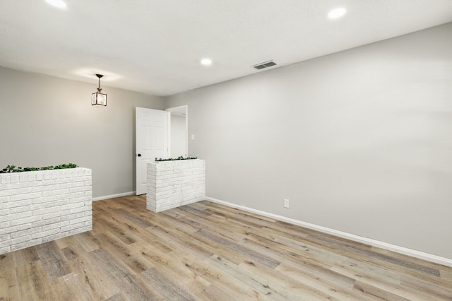 spare room featuring visible vents, recessed lighting, baseboards, and light wood-style floors