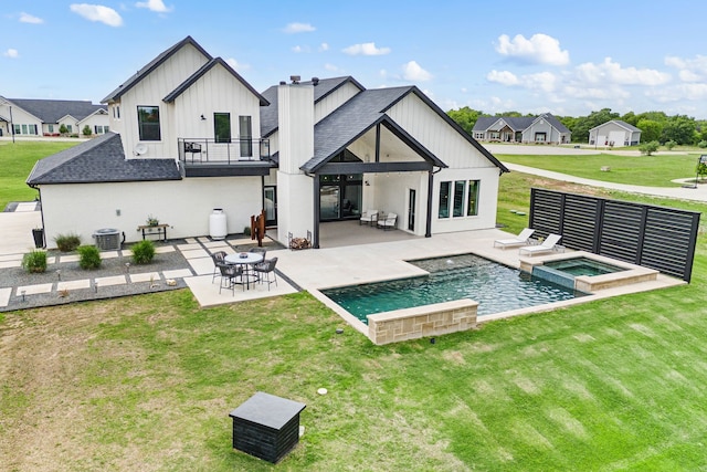 130 Nicholas Way, Decatur, TX 76234 - back of house featuring a balcony, board and batten siding, a yard, a patio area, and central AC