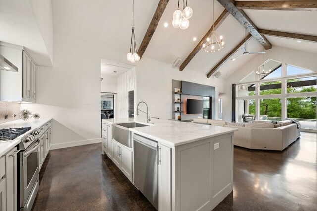 kitchen with open floor plan, high vaulted ceiling, appliances with stainless steel finishes, and an inviting chandelier