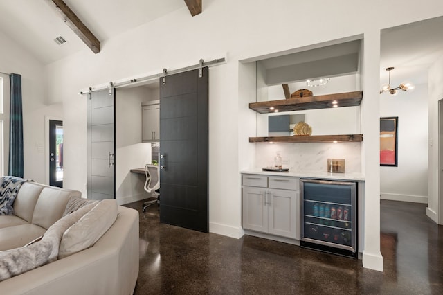 bar featuring a barn door, beverage cooler, baseboards, tasteful backsplash, and a bar