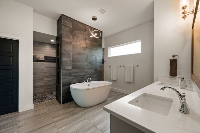 bathroom with double vanity, a sink, a walk in shower, and a freestanding bath