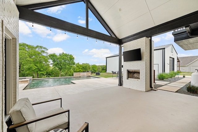 view of patio / terrace with a pool with connected hot tub and an outdoor brick fireplace