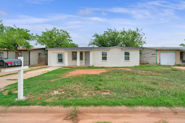 ranch-style house with brick siding, fence, and a front yard