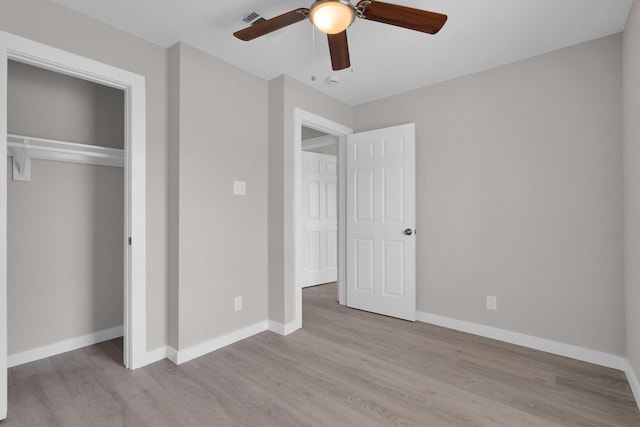 unfurnished bedroom featuring baseboards, visible vents, and light wood-style floors