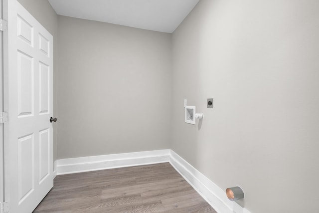 clothes washing area featuring washer hookup, laundry area, baseboards, electric dryer hookup, and wood finished floors