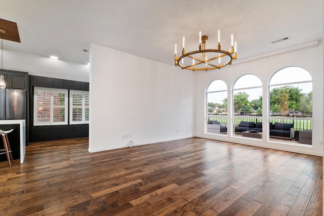 1619 Villa Ct, Corinth, TX 76210 - empty room featuring a chandelier, dark wood-type flooring, and baseboards