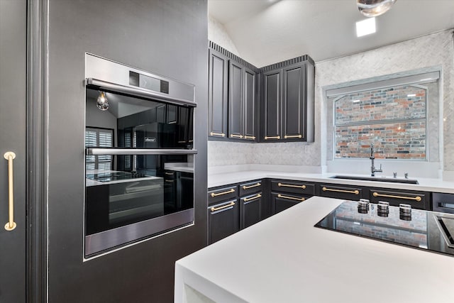 1619 Villa Ct, Corinth, TX 76210 - kitchen featuring a sink, light countertops, black electric cooktop, and lofted ceiling