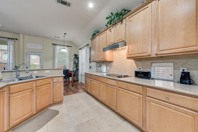 kitchen with decorative backsplash, visible vents, vaulted ceiling, a sink, and black electric stovetop