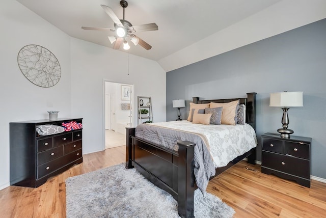 bedroom featuring ceiling fan, wood finished floors, and vaulted ceiling