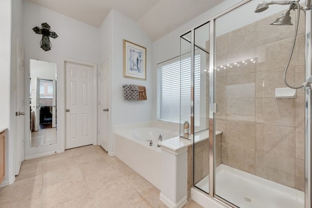 bathroom featuring a garden tub, vaulted ceiling, a stall shower, tile patterned floors, and ensuite bathroom