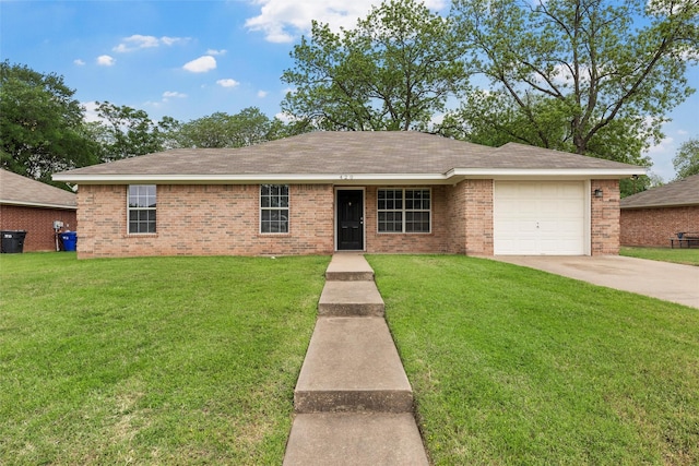 ranch-style home featuring a garage, concrete driveway, a front lawn, and brick siding