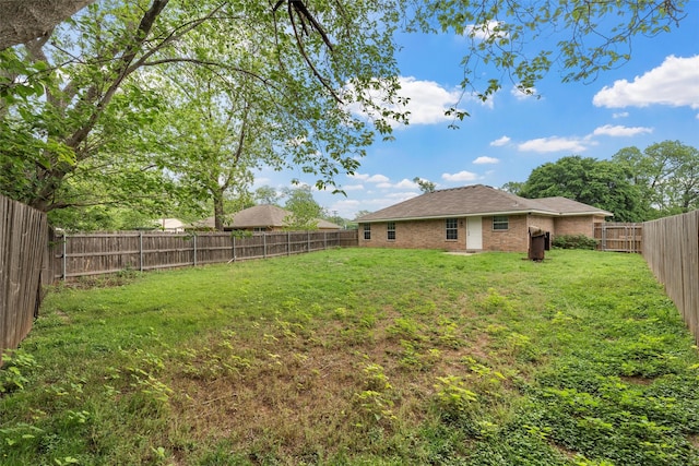view of yard with a fenced backyard